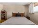 Bedroom with a comfortable bed, side table, and a window providing natural light at 1351 E Ellis Cir, Mesa, AZ 85203