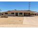 Single story home featuring a large covered carport and desert landscaping at 1351 E Ellis Cir, Mesa, AZ 85203