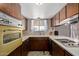 Bright kitchen with ample cabinet space, standard appliances, and plenty of counter space at 1351 E Ellis Cir, Mesa, AZ 85203