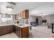 Open kitchen offering natural light, cooktop and connection to living room at 1351 E Ellis Cir, Mesa, AZ 85203