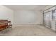 Empty living room featuring a large window and a piano at 1351 E Ellis Cir, Mesa, AZ 85203