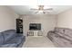 Spacious living room with ceiling fan, comfortable seating, and entertainment center at 1351 E Ellis Cir, Mesa, AZ 85203