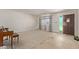 Empty living room features a large window, door, and a piano at 1351 E Ellis Cir, Mesa, AZ 85203