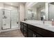 Bathroom featuring double sinks, modern vanity, large mirror, and glass-enclosed shower with a built-in seat at 1360 E Avenida Kino --, Casa Grande, AZ 85122