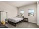 Bedroom showcasing a bed with modern accents, bright windows, and full length mirror at 1360 E Avenida Kino --, Casa Grande, AZ 85122