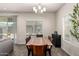 Bright dining room featuring a wood table, modern chandelier, and sliding glass door at 1360 E Avenida Kino --, Casa Grande, AZ 85122