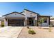 Charming single-story home featuring a modern garage door, low-maintenance landscaping, and neutral color palette at 1360 E Avenida Kino --, Casa Grande, AZ 85122