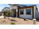Close-up view of a single-story home featuring a modern garage door, low-maintenance landscaping, and neutral color palette at 1360 E Avenida Kino --, Casa Grande, AZ 85122