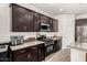 Kitchen area showcasing dark cabinets, stainless appliances, and quartz countertops at 1360 E Avenida Kino --, Casa Grande, AZ 85122