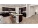 Modern kitchen with a large island, stainless steel appliances, and dark wood cabinets at 1360 E Avenida Kino --, Casa Grande, AZ 85122