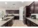 Well-equipped kitchen featuring stainless steel appliances, dark wood cabinets, and quartz countertops at 1360 E Avenida Kino --, Casa Grande, AZ 85122