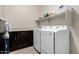 A well-lit laundry room is equipped with modern appliances and ample storage space at 1360 E Avenida Kino --, Casa Grande, AZ 85122