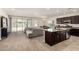 Open-concept living room with kitchen island and backyard view through sliding glass doors at 1360 E Avenida Kino --, Casa Grande, AZ 85122