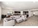 Open-concept living room with gray sectional, wood-look tile flooring, and adjacent kitchen at 1360 E Avenida Kino --, Casa Grande, AZ 85122