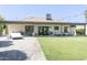 Expansive backyard featuring a covered patio, lush lawn, mature trees, and plenty of space for outdoor activities at 1401 E Drake Dr, Tempe, AZ 85283