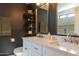 Well-lit bathroom featuring dual sinks, a white vanity, and a large mirror at 1401 E Drake Dr, Tempe, AZ 85283