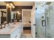 Modern bathroom with a double sink vanity, white cabinets, and a glass-enclosed shower at 1401 E Drake Dr, Tempe, AZ 85283