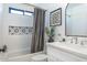 A bathroom features an alcove tub with shower, white tile, and vanity with a light countertop at 1401 E Drake Dr, Tempe, AZ 85283