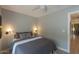 A cozy bedroom with a bed dressed in grey bedding and stylish wall-mounted lamps at 1401 E Drake Dr, Tempe, AZ 85283