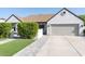 The exterior of the home, featuring a manicured lawn, stucco siding, and a two-car garage at 1401 E Drake Dr, Tempe, AZ 85283