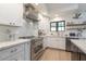 Modern kitchen with stainless steel appliances, white cabinets, and a spacious countertop with seating at 1401 E Drake Dr, Tempe, AZ 85283