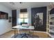 A modern office with black accent wall, white walls, and window at 1401 E Drake Dr, Tempe, AZ 85283