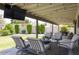 Inviting covered patio with cozy seating, string lights, and a view of the lush, green backyard at 1401 E Drake Dr, Tempe, AZ 85283