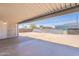 Covered patio looks out onto a large backyard with a chain link fence at 1526 W North Ln, Phoenix, AZ 85021
