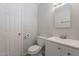 Bathroom featuring toilet, white vanity, framed mirror and grey walls at 1526 W North Ln, Phoenix, AZ 85021