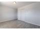 A well-lit bedroom features wood-look tile flooring and a closet with sliding doors at 1526 W North Ln, Phoenix, AZ 85021