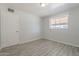 This bright bedroom features neutral paint, wood-look tile flooring, and a window at 1526 W North Ln, Phoenix, AZ 85021