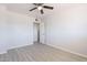 Bedroom features wood-look tile floors, neutral paint, and an open closet at 1526 W North Ln, Phoenix, AZ 85021