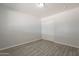 Cozy bedroom featuring wood-look tile flooring and a spacious closet with sliding doors at 1526 W North Ln, Phoenix, AZ 85021