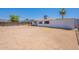 Back exterior view of house with large backyard and covered patio at 1526 W North Ln, Phoenix, AZ 85021