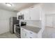 Stylish kitchen featuring granite counters, subway tile backsplash, and modern stainless steel appliances at 1526 W North Ln, Phoenix, AZ 85021