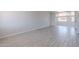 Large living space featuring tile flooring and a sunlit window at 1526 W North Ln, Phoenix, AZ 85021