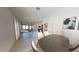 Open-concept dining area with bar seating, a large table, and views into the kitchen and living areas at 15504 W Corte Del Sol Este --, Waddell, AZ 85355