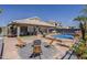 Inviting backyard featuring a tiled patio, pool, trampoline, comfortable seating, and a charming firepit area at 16426 S 29Th St, Phoenix, AZ 85048