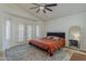 A bedroom with a ceiling fan and a bed with an orange comforter set at 16426 S 29Th St, Phoenix, AZ 85048