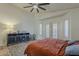 A bedroom with a ceiling fan and a dark console with storage at 16426 S 29Th St, Phoenix, AZ 85048