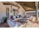 Comfortable covered patio featuring cushioned seating, ceiling fans, and stylish decor, perfect for outdoor relaxation at 16426 S 29Th St, Phoenix, AZ 85048