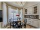 Cozy dining area with chandelier lighting, a round table, and white curtains near the custom kitchen at 16426 S 29Th St, Phoenix, AZ 85048