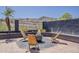 Cozy backyard firepit area with a brick-paved patio and black metal chairs overlooking a mountain at 16426 S 29Th St, Phoenix, AZ 85048