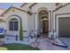 Inviting front entrance with arched doorway, desert landscaping, tiled walkway, and an ADT security system at 16426 S 29Th St, Phoenix, AZ 85048
