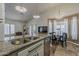 Bright eat-in kitchen featuring granite counters, stainless steel sink, pendant lights, and adjacent dining area at 16426 S 29Th St, Phoenix, AZ 85048