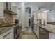 Modern kitchen featuring stainless steel appliances, granite countertops, tile backsplash, and tile flooring throughout at 16426 S 29Th St, Phoenix, AZ 85048