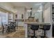Spacious kitchen featuring granite countertops, breakfast bar, tile floors, and an adjacent dining area at 16426 S 29Th St, Phoenix, AZ 85048