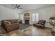Cozy living room with stone fireplace, two leather couches, tile flooring, and large windows with shutters at 16426 S 29Th St, Phoenix, AZ 85048