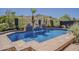 Private pool with blue tile, waterfall features, and desert landscaping at 16426 S 29Th St, Phoenix, AZ 85048