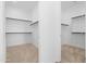 Double walk-in closets with shelving and clothing rods at 17051 W West Wind Dr, Surprise, AZ 85387